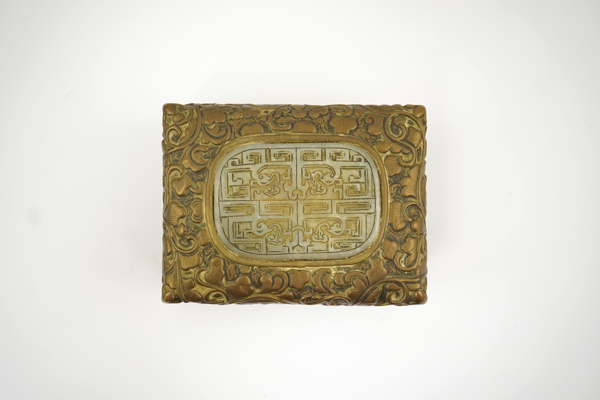 A Chinese brass 'dragon' box, inset with a 17th/18th century jade plaque